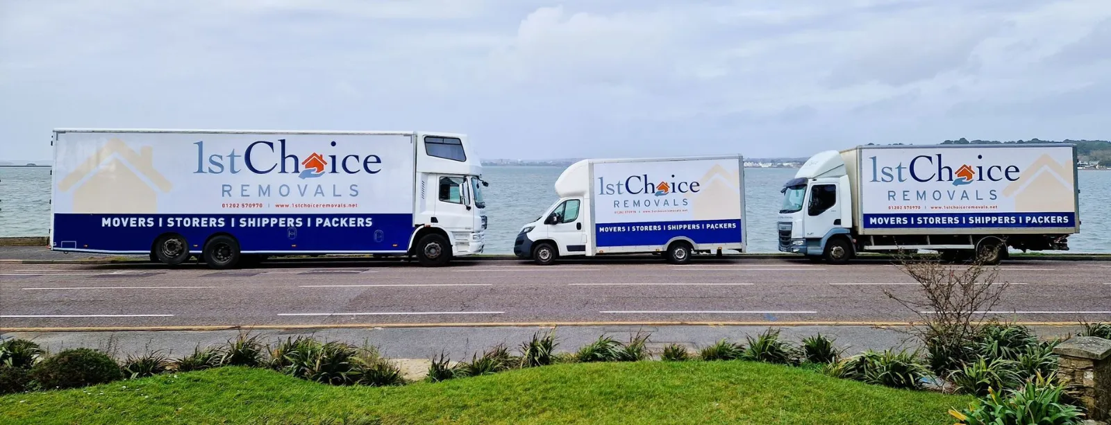 Three 1st Choice Removals lorries parked on the seafront