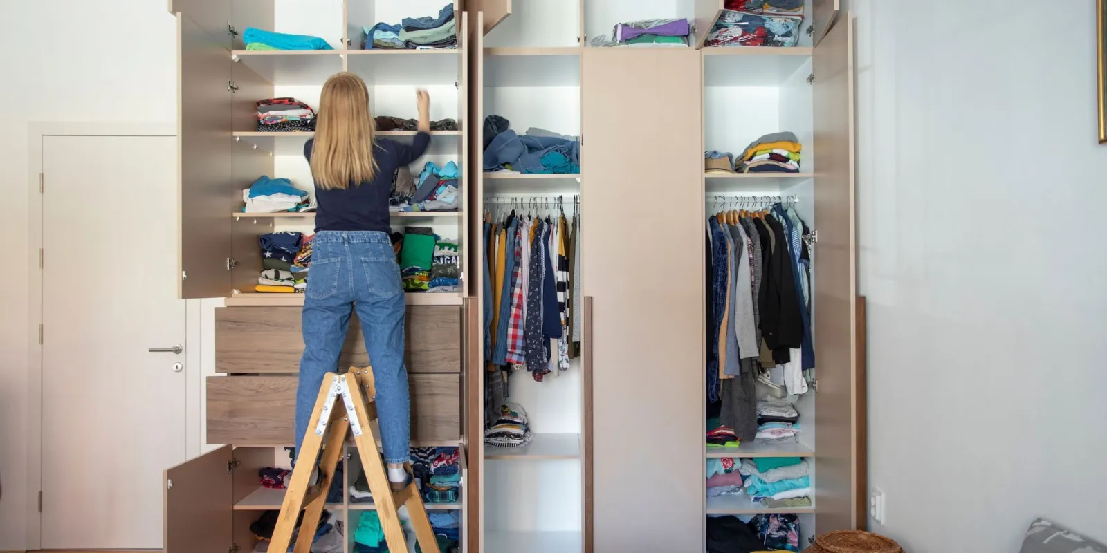 A wardrobe being sorted through as part of decluttering before a move